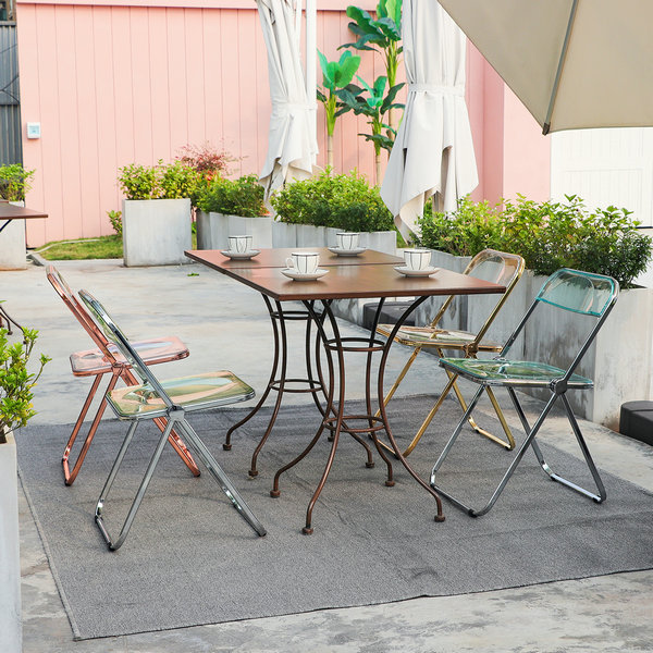 clear folding chairs by cafe table outdoor.jpg